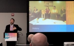 A photo of Michael Di Giovine speaking about the history of ATIG during the ATIG business meeting in Toronto, 2023.